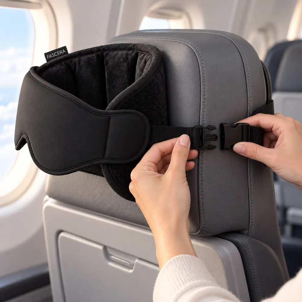 Hands securing the sleep sling strap around an airplane headrest